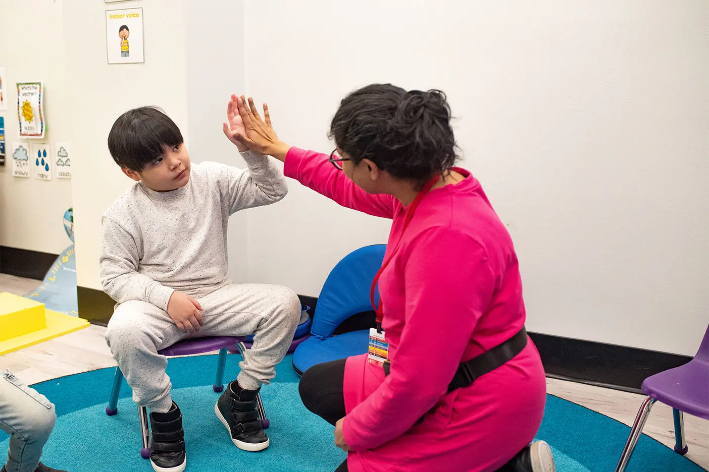 Child receiving sensory regulation support through structured therapy activities designed to improve tolerance and focus.